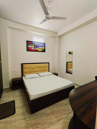 a bedroom with a bed and a table in it at S P Residency in Lucknow