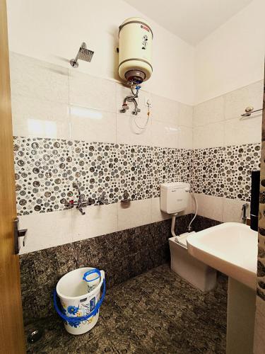 a bathroom with a toilet and a sink at S P Residency in Lucknow