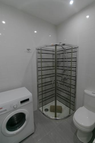 a bathroom with a washing machine and a toilet at Sea Steps Marsalforn in Marsalforn
