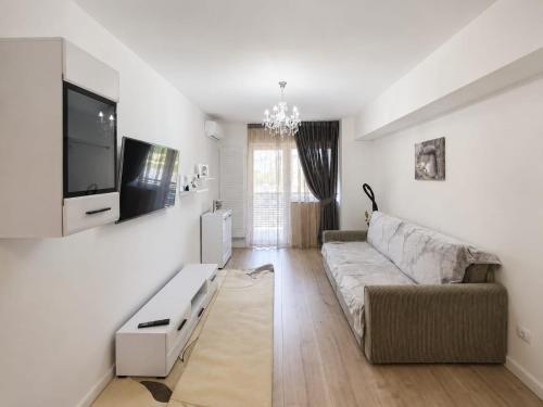 a living room with a couch and a tv at Abel 27 Residence in Bacău