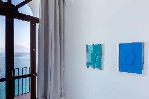 a room with a window with a view of the ocean at Grand Hotel Europa Palace Sorrento in Sorrento