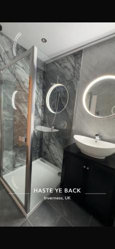 a bathroom with a sink and a mirror at Haste Ye Back in Inverness