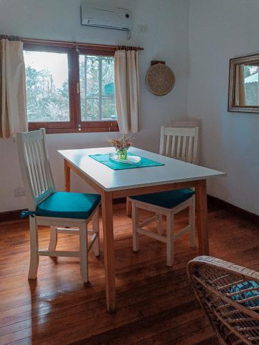 a dining room table with two chairs and a table at Quinta Las Marías - Domingos Check out 17 hs in Tigre