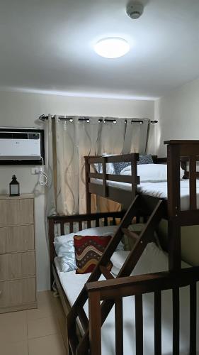 a room with three bunk beds in a room at Keyspace condotel in Piapi