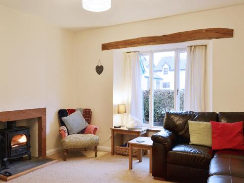 a living room with a couch and a fireplace at Beny Cot in Keswick