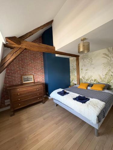 a bedroom with a bed and a brick wall at Vue incroyable Loire et Chateau in Amboise