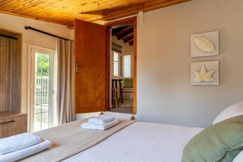a bedroom with a bed with towels on it at Pnoes Suites Apartments in Skiathos