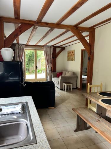 a living room with a couch and a table at Chez Jallot - Lower Gite in Vidaillat