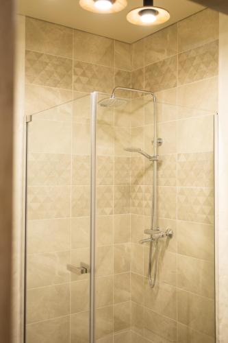 a shower with a glass door in a bathroom at Заміський комплекс Lisovi Polyany in Novosëlovka