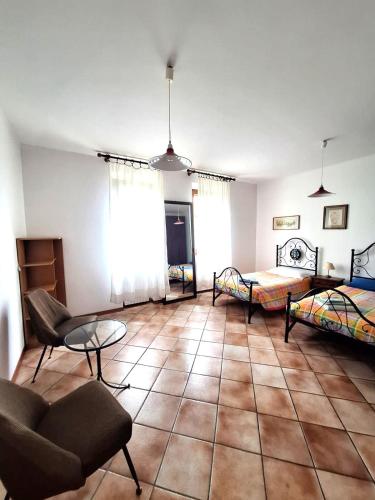 a living room with two beds and a couch at Le Corolle in Montepulciano