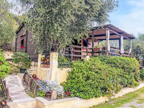 a house with a garden in front of it at Holiday Home Le Terrazze del Geco Bungalow B - SLR301 by Interhome in San Lorenzo al Mare