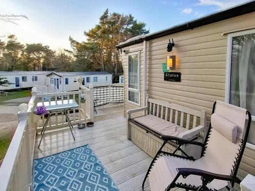 a deck with two chairs and a bench on a house at 5 Pine Rise in Poole