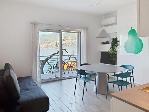 a kitchen and living room with a table and chairs at Apartment La Maison Blanche-1 by Interhome in Brenzone sul Garda