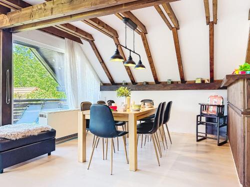 a kitchen and dining room with a wooden table and chairs at Holiday Home Ferienpark Vorauf-4 by Interhome in Molberting