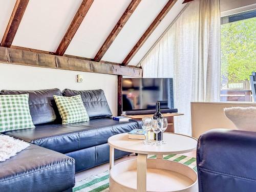 a living room with a couch and a table at Holiday Home Ferienpark Vorauf-4 by Interhome in Molberting