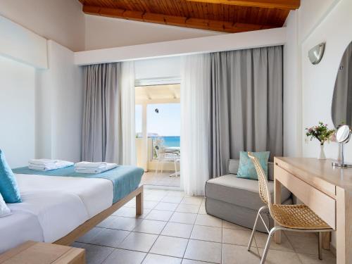a hotel room with a bed and a desk at GK Beach Hotel in Kalyves
