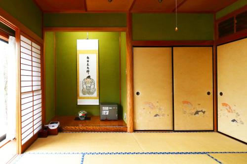 an entrance to a room with green walls and doors at Ryokan Karasawa in Kanazawa