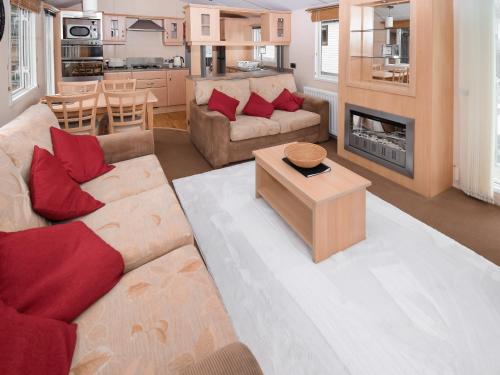 a living room with a couch and a table at Stanley's Sanctuary in Boot