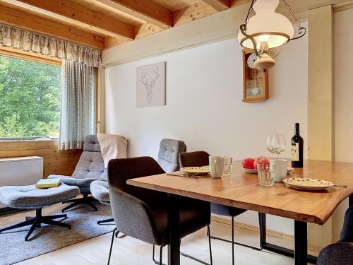 a dining room with a wooden table and chairs at Apartment Fliederweg by Interhome in Siegsdorf