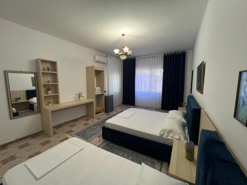 a hotel room with a bed and a mirror at Vila BriArt in Durrës