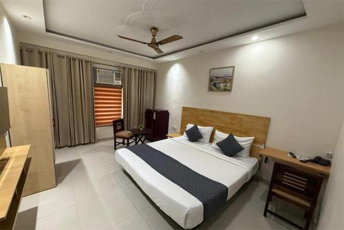 a hotel room with a bed and a desk and a bed sidx sidx at Cloud Bay Hotels - Sector 69 in Gurgaon