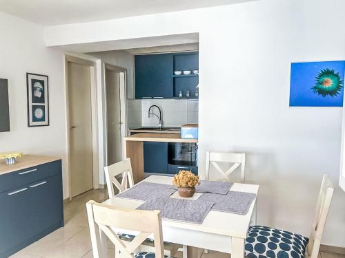 a kitchen and dining room with a table and chairs at Apartment Renata by Interhome in Barić Draga