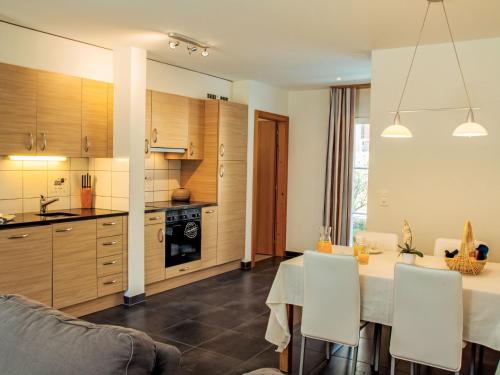a kitchen and dining room with a table and chairs at Apartment Andromède 3-pièces A34 by Interhome in Moleson