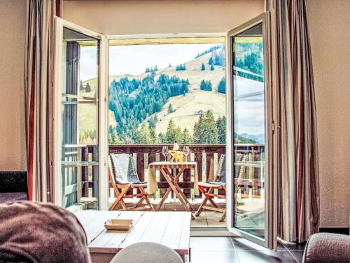 a balcony with a table and a view of a mountain at Apartment Andromède 3-pièces A34 by Interhome in Moleson