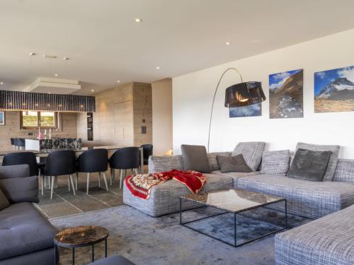 a living room with two couches and a bar at Apartment Le Refuge 1 by Interhome in Nendaz