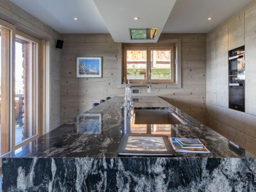 a kitchen with a large marble counter top at Apartment Le Refuge 1 by Interhome in Nendaz