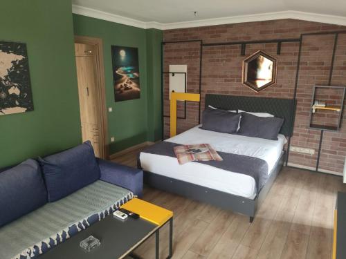 a bedroom with a bed and a couch at BUTİK 24 SUİTES in Ankara