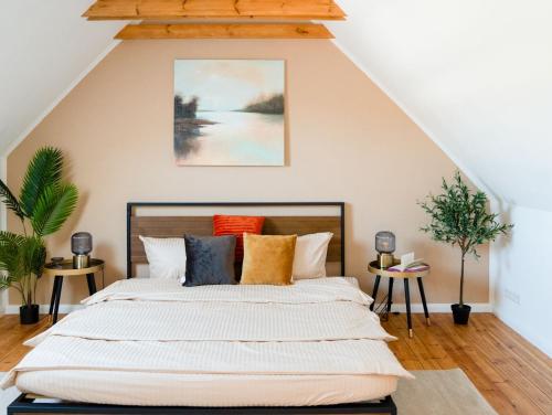 a bedroom with a large bed with colorful pillows at Travetraum in Lübeck