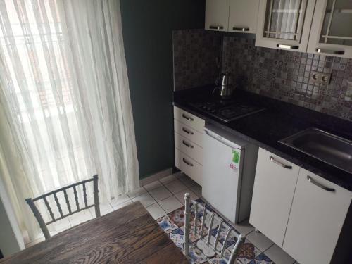 a small kitchen with a sink and a stove at BUTİK 24 SUİTES in Ankara