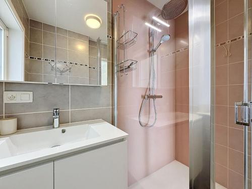 a bathroom with a sink and a shower at Apartment Westhinder with balcony by Interhome in Blankenberge