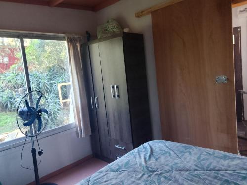 a bedroom with a bed and a window at Sol naciente in Jaureguiberry