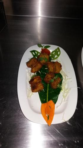 a white plate with food on a table at Ranthambhore Tiger Valley in Sawāi Mādhopur