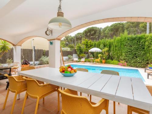 a dining room with a table and chairs and a pool at Holiday Home Florencia by Interhome in Pals