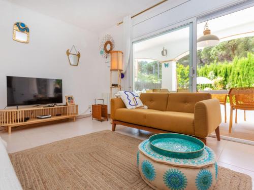 a living room with a couch and a tv at Holiday Home Florencia by Interhome in Pals
