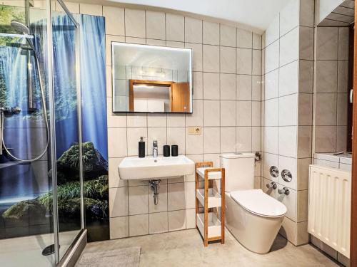 a bathroom with a sink and a toilet and a shower at Apartment Apartment Wuff by Interhome in Altendorf