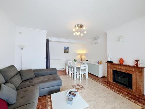 a living room with a couch and a fireplace at Holiday Home Requesens by Interhome in Empuriabrava
