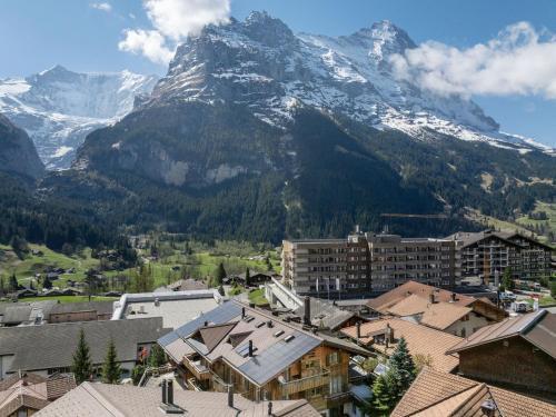 a view of a mountain with a town and buildings at Apartment Chalet Abendrot apARTments-32 by Interhome in Grindelwald