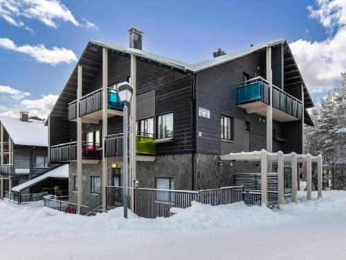 a house in the snow with a lot of snow at Holiday Home Levin stara a09 by Interhome in Levi