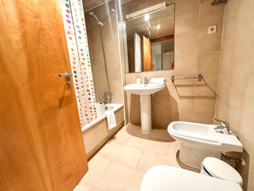 a bathroom with a toilet and a sink at Two bedroom apartment behind the Rambla in Girona