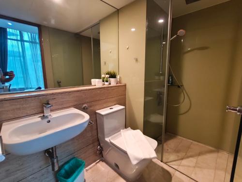 a bathroom with a sink and a toilet and a shower at Vortex Residence KLCC by Valen in Kuala Lumpur