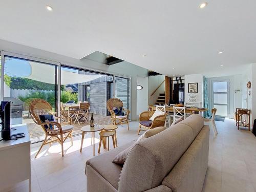 a living room with a couch and a table and chairs at Holiday Home Ker Bernic by Interhome in Piriac-sur-Mer