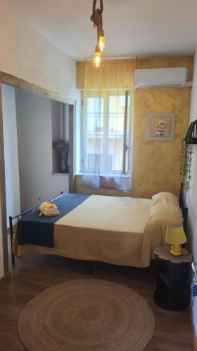 a bedroom with a large bed with a window at B&B Dimora del centro in Scalea