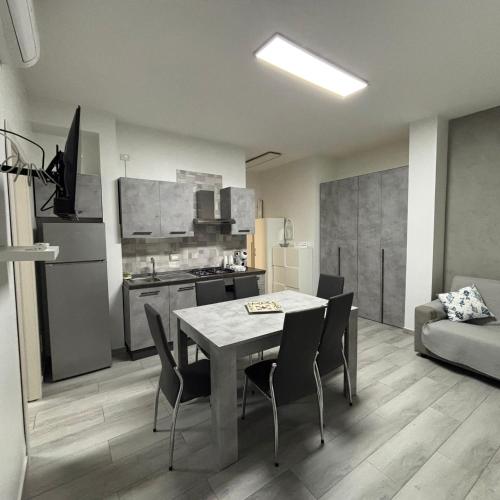 a kitchen and dining room with a table and chairs at Nido di Pace in Giardini Naxos