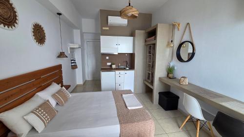 a small room with a bed and a kitchen at Edelweiss Rent Rooms-Rent a Car in Tsoutsouros