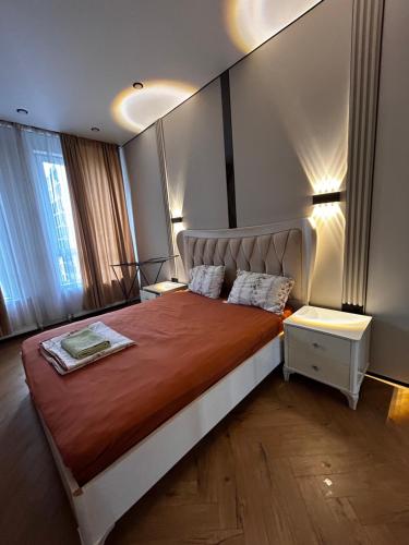 a bedroom with a large bed in a room at River city-Сайран in Almaty