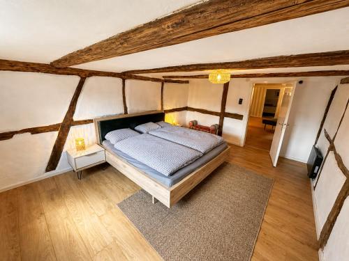 a bedroom with a bed in a room with wooden ceilings at Anis Obsthof in Bad Arolsen